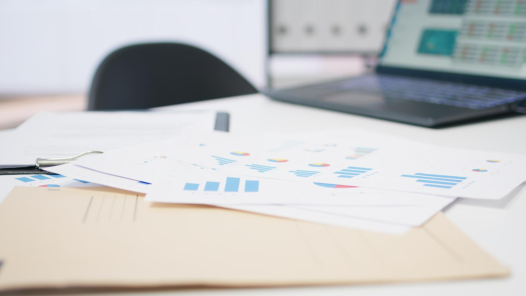 desk with laptop and papers
