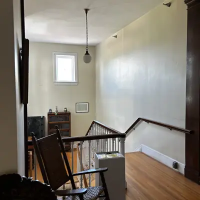 Staircase in south wing of 1924 addition looking down at the landing.