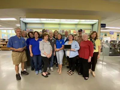 Photo of the Lions Club and Library staff with the device.