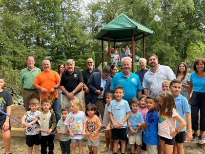 families and town officials at the grand reopening of the Blackberry Woods playground