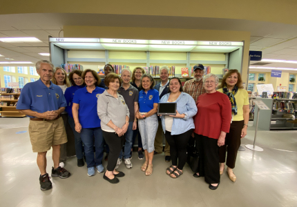 A photo of Lions Club members and Library staff with the new device.