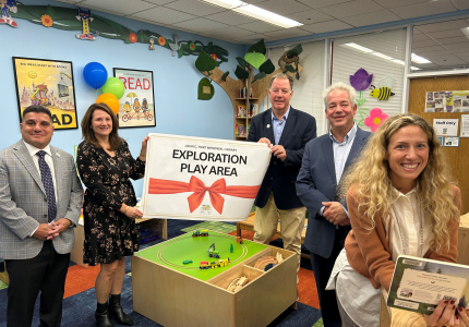 Town officials in the new exploration play area at the Hart Library.