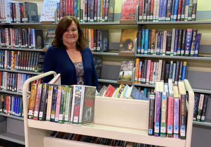 Yorktown library clerk Jean Fischer stacks books.