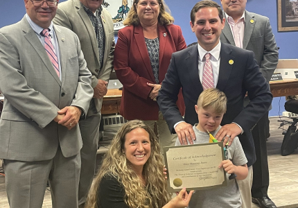 Members of the Town Board and the Town Clerk with Riley Manning-Burns on July 5, 2022, at Town Hall.