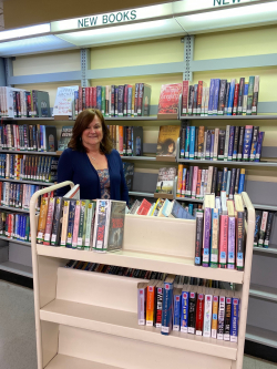 Yorktown library clerk Jean Fischer stacks books.