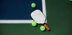 Image of pickleball racket and balls on a court